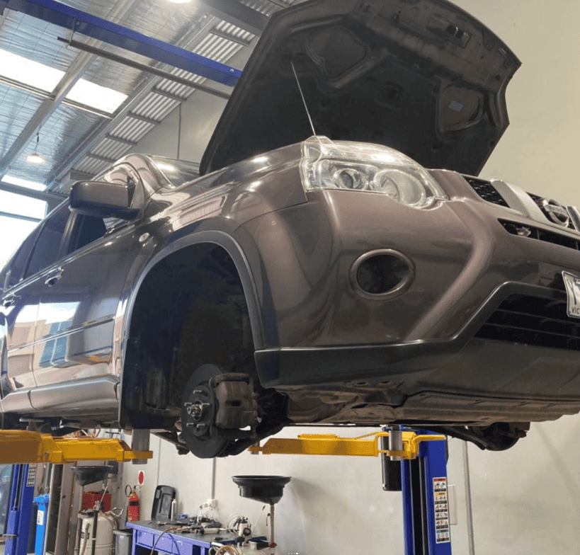 roadworthy certificate deer park nissan mini SUV on hoist